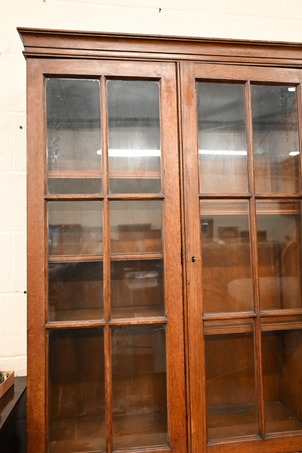 An early 20th century oak cabinet bookcase, the top section with glazed doors enclosing adjustable - Image 2 of 5
