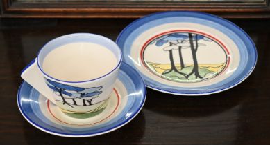 A Wedgwood Clarice Cliff Centenary Bizarre tea cup, saucer and plate decorated with 'Blue Firs'