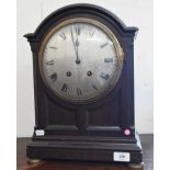 A French oak bracket clock with silvered dial, striking on a coiled gong, 44 cm high