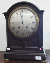 A French oak bracket clock with silvered dial, striking on a coiled gong, 44 cm high