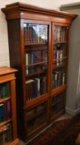 A 19th century mahogany bookcase with adjustable shelving and glazed doors, 116 cm x 34 cm x 174