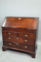 An 18th century oak bureau, the fall enclosing a fitted interior of niches and slide top well over