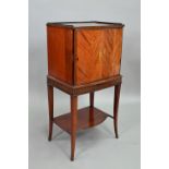 An Edwardian mahogany cellarette / drinks cabinet, of slender bowfront form, the single door