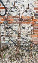 A pair of weathered steel arrowhead obelisks (2)