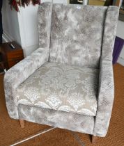 A contemporary grey/brown upholstered armchair, raised on beech legs