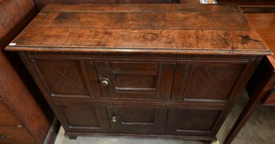 An 18th century oak pantry cupboard of panelled construction with two small doors, 102 cm wide x