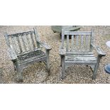 A pair of weathered Lister teak garden armchairs (2)