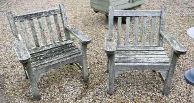 A pair of weathered Lister teak garden armchairs (2)