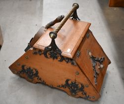 An Edwardian oak purdonium with brass rope-twist handle and copper shovel, 40 cm high