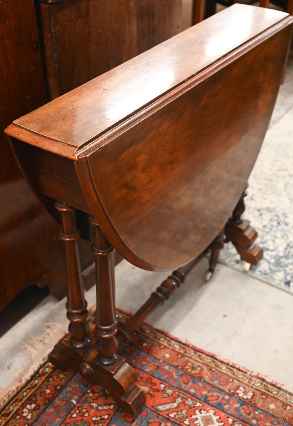 A Victorian mahogany Sutherland table with turned gate-leg action supports