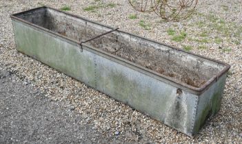 A large weathered riveted galvanised agricultural water trough, 214 cm x 47 cm x 40 cm h, note patch