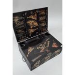 An early 20th century Japanese black lacquered brass mounted writing box with twin hinged top and