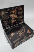 An early 20th century Japanese black lacquered brass mounted writing box with twin hinged top and