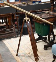 A reproduction brass telescope, 100 cm long, on adjustable wooden tripod