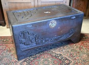 A 1930's Chinese stained and carved camphorwood trunk, with original tray to the interior and