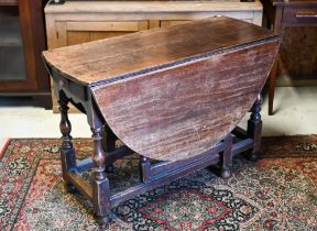 An antique oak gateleg table with single drawer to one end, later toes, 107 cm (136 cm open) x 46 cm