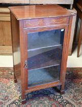 A Sheraton revival inlaid satinwood music cabinet, with single glazed door, on square spade end
