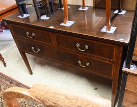 An Edwardian cross-banded walnut three drawer sideboard, raised on square tapering legs on brass