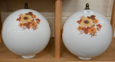 Two globular glass ceiling lightshades with floral-printed decoration