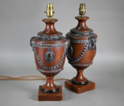 A pair of composite classical urn table lamps
