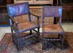 A set of six oak framed brass studded brown leather dining chairs in the 17th century style,
