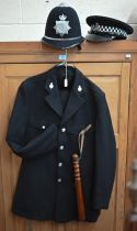A North Yorkshire policeman's uniform comprising helmet, peaked cap, tunic, trousers and truncheon