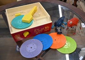 A vintage Fisher-Price plastic Music Box Record Player with five 'records' to/w a Tri-ang