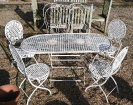 A painted metal lattice-work patio set comprising table, four chairs, two parasols to/w painted