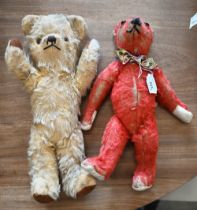 A vintage red-plush teddy-bear with glass eyes, stitched nose and rotating limbs with replacement