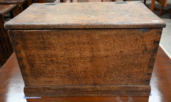 An antique dove-tailed elm trunk with hinged top and flush brass campaign style handles, 66 x 36 x
