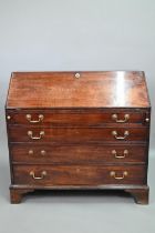 A George III mahogany bureau, the well fitted interior with leather faux book spine 'secret' storage