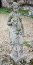 A weathered cast stone garden statue of a classical maiden