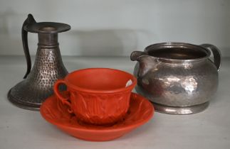 A Tudric planished pewter milk-jug, model 01075, to/w an Abbey pewter chamberstick and a 19th