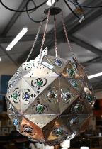 A Middle Eastern pierced copper ceiling lightshade of faceted globular form, set with coloured glass