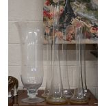 A large glass vase on short-stemmed foot, 69 cm high, to/w a 79 cm high vase flute and four matching