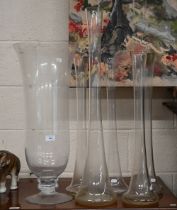 A large glass vase on short-stemmed foot, 69 cm high, to/w a 79 cm high vase flute and four matching