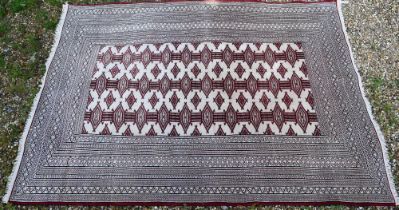 Turkoman Tekke camel ground rug, the design of repeating guls in red, 176 cm x 127 cm