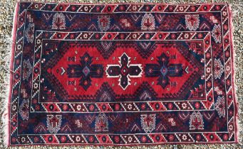 A Turkish Dosemealti rug, three diamond cruciform medallions on red ground, with blue 'Scorpion'