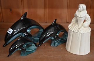 A Poole pottery figure of Queen Elizabeth I, 24 cm, to/w a graduated set of three Poole dolphins (4)