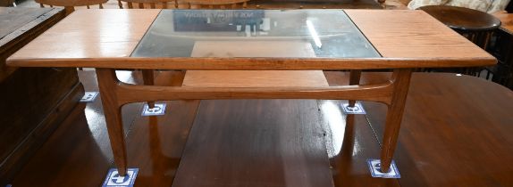 A mid-century G-Plan (unmarked) teak coffee table with inset central glass panel over open