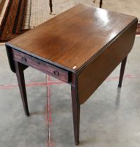 A 19th century mahogany Pembroke table on tapering square supports