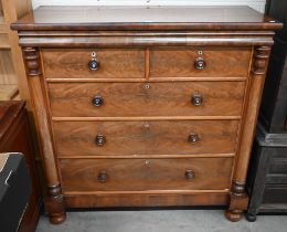 A large Victorian figured mahogany chest with shallow cavetto drawer over two short and three long