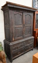 An 18th century and later oak livery cupboard with panelled doors on base with two drawers below