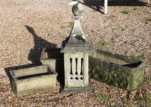 A reconstituted weathered stone Portuguese chimney pot, 90 cm high, two cast stone trough planters