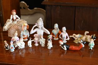 A collection of vintage china pin-cushion figures and reclining female figures, etc