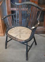 An Arts & Crafts cane seat spindle back elbow chair