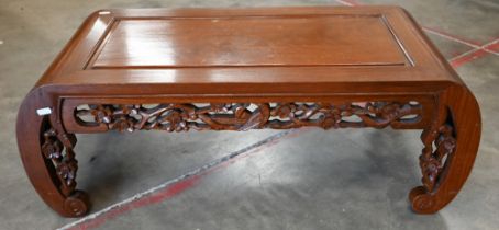 A 20th century Chinese hardwood small coffee table with scroll legs and bird and prunus design