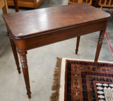 A 19th century mahogany folding tea table on ring turned supports, 90 x 45 x 72 cm high