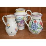 Three Poole Pottery floral-painted jugs, 21.5 - 18 cm (3 - largest chipped under foot)
