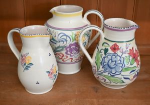 Three Poole Pottery floral-painted jugs, 21.5 - 18 cm (3 - largest chipped under foot)